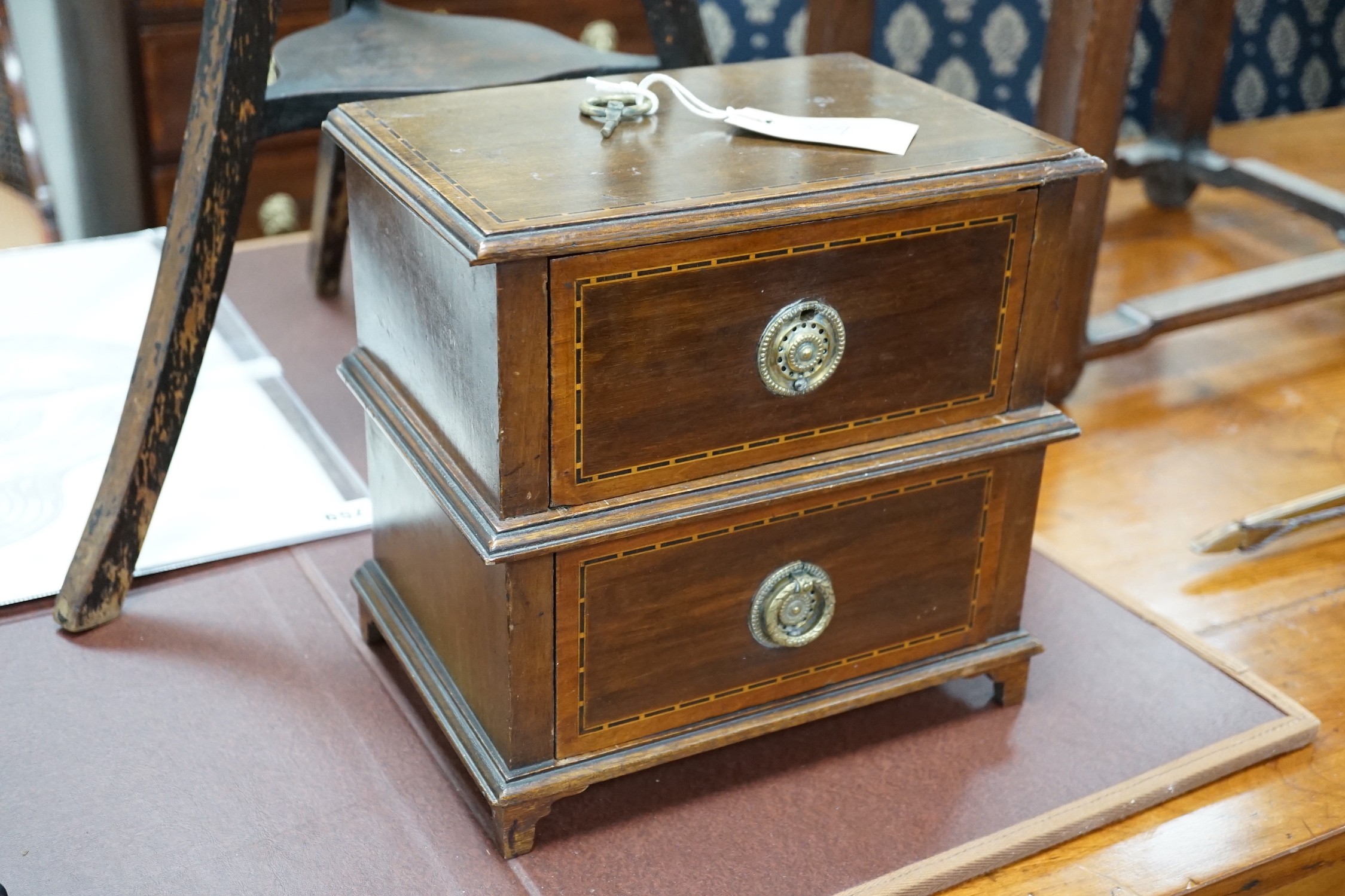 An Edwardian ebonised jardiniere stand with brass liner, width 46cm, depth 46cm, height 85cm, and a miniature two drawer chest *Please note the sale commences at 9am.